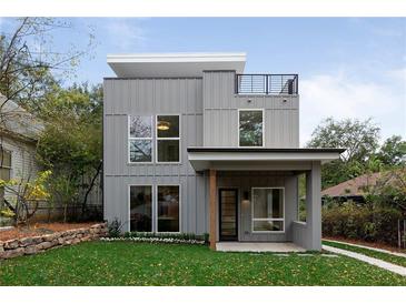 Modern two-story home featuring a rooftop deck and gray vertical paneling at 1186A Francis Nw St, Atlanta, GA 30318