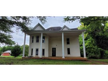 Two-story home featuring a large front porch supported by stately columns at 119 E Johnson St, Temple, GA 30179