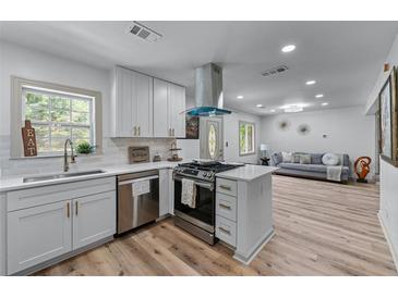 Bright kitchen with stainless steel appliances, white cabinets and an eat-in kitchen island at 1819 Waldrep Se Cir, Marietta, GA 30060