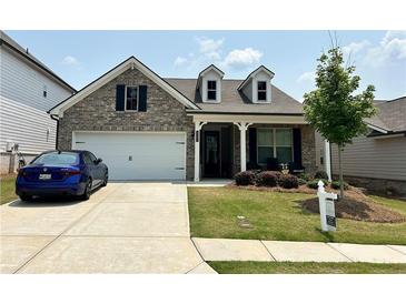 Charming single-Gathering home featuring a two-car garage, well-kept lawn, and inviting front porch at 3397 Long Creek Drive, Buford, GA 30519