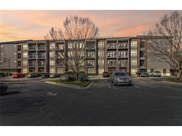 Stylish condo building with balconies, beautiful landscaping, and ample parking for residents and guests at 840 United Avenue Southeast # 401, Atlanta, GA 30312