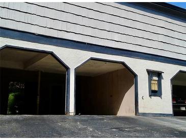 View of the open garage with three spaces, offering ample parking and storage at 1419 Stone Mill Trce, Stone Mountain, GA 30083