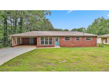 Charming single-story brick home with a spacious front yard and attached carport at 191 Pine Ne St, Fairburn, GA 30213