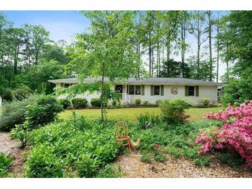 Charming single-story home with well-manicured lawn and mature trees at 5839 Darry Cir, Norcross, GA 30093