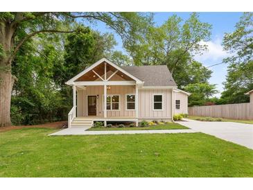 Charming single-story home with a well-manicured lawn and inviting front porch at 1036 Dell Se Ave, Smyrna, GA 30080