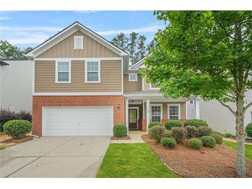 Charming two-story home with a well-manicured lawn, a two-car garage, and a welcoming front entrance at 728 Lorimore Pass, Canton, GA 30115
