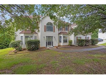 Charming two-story home with light siding, complemented by well-manicured hedges and a welcoming entrance at 3885 Riverview Chase Blf, Ellenwood, GA 30294