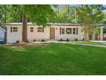 Charming one story home with a freshly manicured lawn and painted brick exterior at 2595 Elkhorn Dr, Decatur, GA 30034