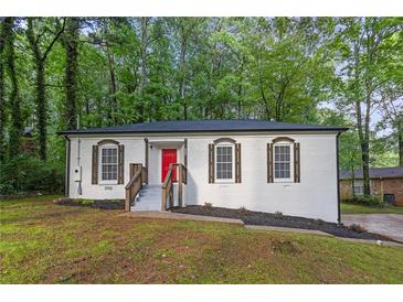 Charming renovated bungalow features a red front door and freshly painted exterior at 4698 Fellsridge Dr, Stone Mountain, GA 30083