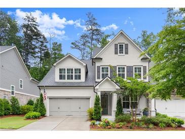 Beautiful two-story home featuring gray painted brick, gray shutters, and a well-manicured lawn at 124 Calder Dr, Alpharetta, GA 30009