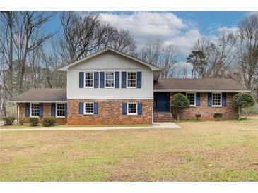 Charming brick home featuring blue shutters and a well-maintained front yard, offering a classic and inviting curb appeal at 2270 Old Concord Se Dr, Covington, GA 30016