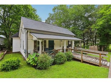 Charming cottage-style home with a welcoming front porch and a convenient handicap ramp at 2860 Jefferson St, Austell, GA 30106