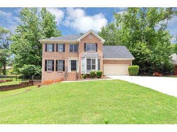 Charming two-story brick home with well-manicured lawn and attached two-car garage at 4810 Habersham Se Way, Conyers, GA 30094