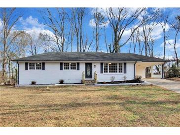 Charming single-story home with white brick exterior and well-maintained landscaping at 5774 Forest Dr, Acworth, GA 30102