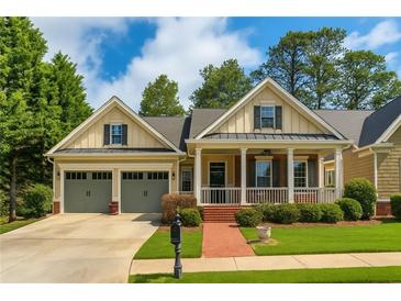 Charming single-Gathering home with a welcoming front porch, a well-manicured lawn, and a two-car garage at 730 Jackson Miller Cir, Powder Springs, GA 30127