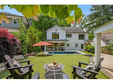 Beautiful backyard featuring a pool, patio with fire pit and well-manicured landscaping at 1168 Mclynn Ne Ave, Atlanta, GA 30306