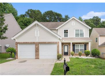 Charming two-story home with a two-car garage and well-maintained front yard at 1576 Thornwick Trce, Stockbridge, GA 30281