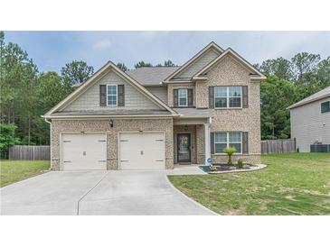 Charming two-story home featuring a brick facade, well-manicured lawn, and a two-car garage for curb appeal at 446 Vandenburg Dr, Villa Rica, GA 30180