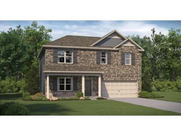 Charming two-story home featuring brick facade, gray shutters, covered entry, and a well-manicured lawn at 1208 Arnhem Dr, Hampton, GA 30228