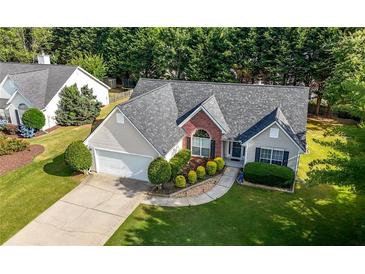 Aerial view of a well-maintained house, landscaped yard, and neighborhood at 3313 Harmon Ridge Ct, Buford, GA 30519