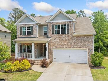 Charming two-story brick home with a well-manicured lawn and covered front porch at 178 Crestbrook Way, Dallas, GA 30157