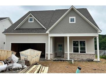 Charming single-Gathering home features a craftsman-style design and an attached two-car garage at 2000 Homestead Ct, Woodstock, GA 30189