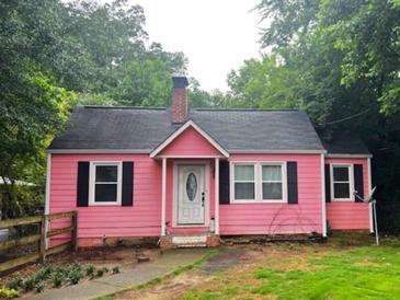 Charming pink home with black shutters and a well-maintained front yard at 207 Walthall Nw St, Marietta, GA 30064