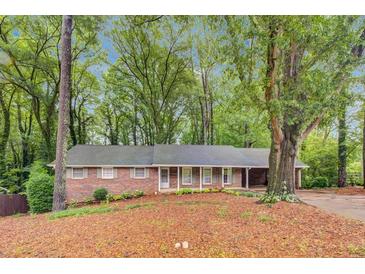 Charming one-story brick home with large, mature trees, lovely greenery and a nice front yard at 333 Lynne Cir, Alpharetta, GA 30009