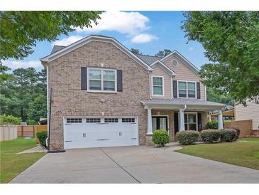 Charming two-story brick home with a well-maintained lawn and attached two car garage at 4945 Racquet Ct, Duluth, GA 30096