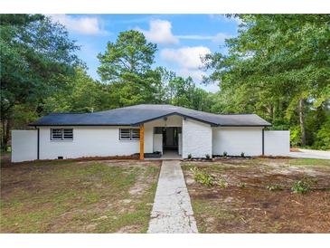Charming single story home with a painted brick facade, and newly landscaped front yard at 1377 Hill Sw Dr, Conyers, GA 30094