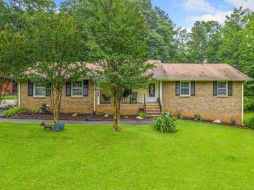 Charming single-story brick home with a well-manicured front yard and mature trees at 2095 Gherry Dr, Austell, GA 30106