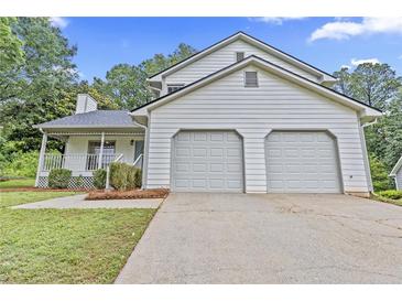 Charming home featuring a two-car garage and welcoming front porch perfect for enjoying the outdoors at 6402 Grafton Ct, Austell, GA 30168