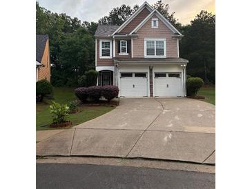 Charming two-story home with a two-car garage and a well-manicured front yard at 162 Ledgewood Mill Way, Lawrenceville, GA 30045