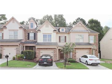 Charming townhome with a well-manicured lawn and inviting curb appeal at 3130 Haynes Park Dr, Lithonia, GA 30038