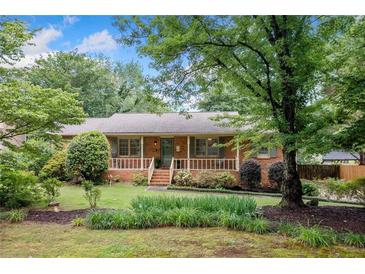 Charming brick home with well-maintained landscaping and a cozy front porch at 2578 Morgan Lake Ne Dr, Marietta, GA 30066