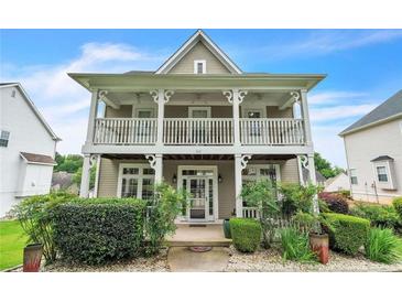 Charming two-story home featuring a welcoming front porch and landscaped front yard at 266 Monarch Village Way, Stockbridge, GA 30281