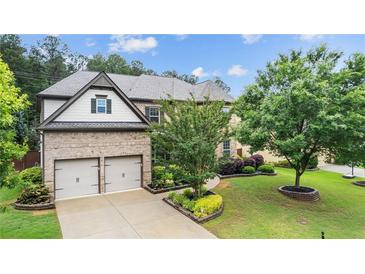 Beautiful two-story brick home with a two car garage and manicured lawn at 2040 Bloomfield Ct, Cumming, GA 30041