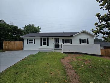 Charming home features a well-maintained front yard and classic architectural details for a welcoming curb appeal at 766 Longleaf Dr, Forest Park, GA 30297