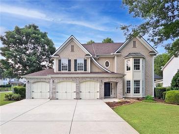 Charming two-story home featuring a three-car garage and well-maintained landscaping at 3260 Caney Creek Ln, Cumming, GA 30041