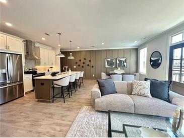 Bright living room featuring an open layout to the kitchen and contemporary decor at 520 Sawnee Village Blvd # D58, Cumming, GA 30040
