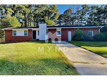 Charming single-story brick home with a well-maintained lawn and a concrete driveway at 7054 Chappell Cir, Atlanta, GA 30360