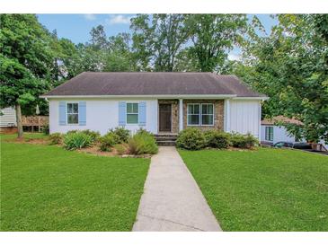Charming single-story home featuring a well-manicured lawn and inviting stone-accented entrance at 792 Mimosa Se Dr, Marietta, GA 30060