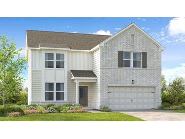 Charming two-story home featuring a brick facade, attached garage, and a well-manicured lawn at 1405 Windance Lake Dr, Loganville, GA 30052
