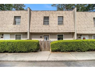 Charming townhome featuring a unique roofline and tidy front yard landscaping at 6433 Stone Terrace Ter, Morrow, GA 30260