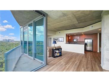 Bright living room featuring hardwood floors, floor-to-ceiling windows, and stainless steel appliances at 3300 Windy Ridge Se Pkwy # 1121, Atlanta, GA 30339