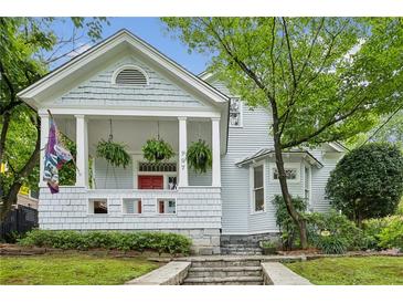 Charming home featuring a covered front porch, beautiful landscaping, and a quaint, historic design at 797 Ashland Ne Ave, Atlanta, GA 30307