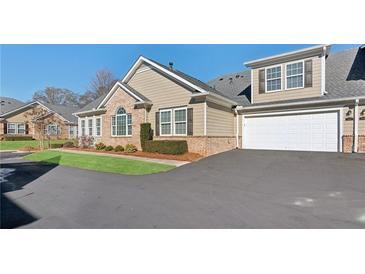 Inviting townhouse with a two-car garage, lush lawn, and lovely landscaping at 2565 Grapevine Cir # 103, Cumming, GA 30041