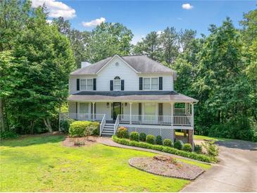 Charming two-story home with a welcoming front porch and well-manicured lawn at 308 Golden Ct, Canton, GA 30114