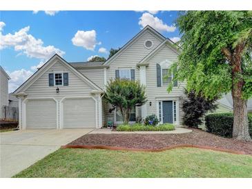 Beautiful two-story home featuring a well-maintained lawn and a two-car garage at 12060 Carriage Park Ln, Duluth, GA 30097