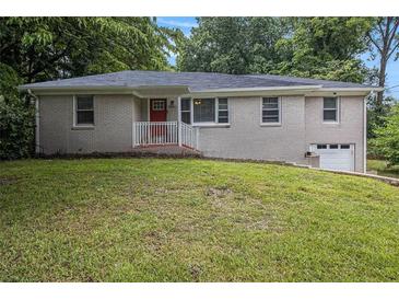 Charming brick home with a well-maintained lawn and inviting red front door at 1955 Vicki Se Ln, Atlanta, GA 30316